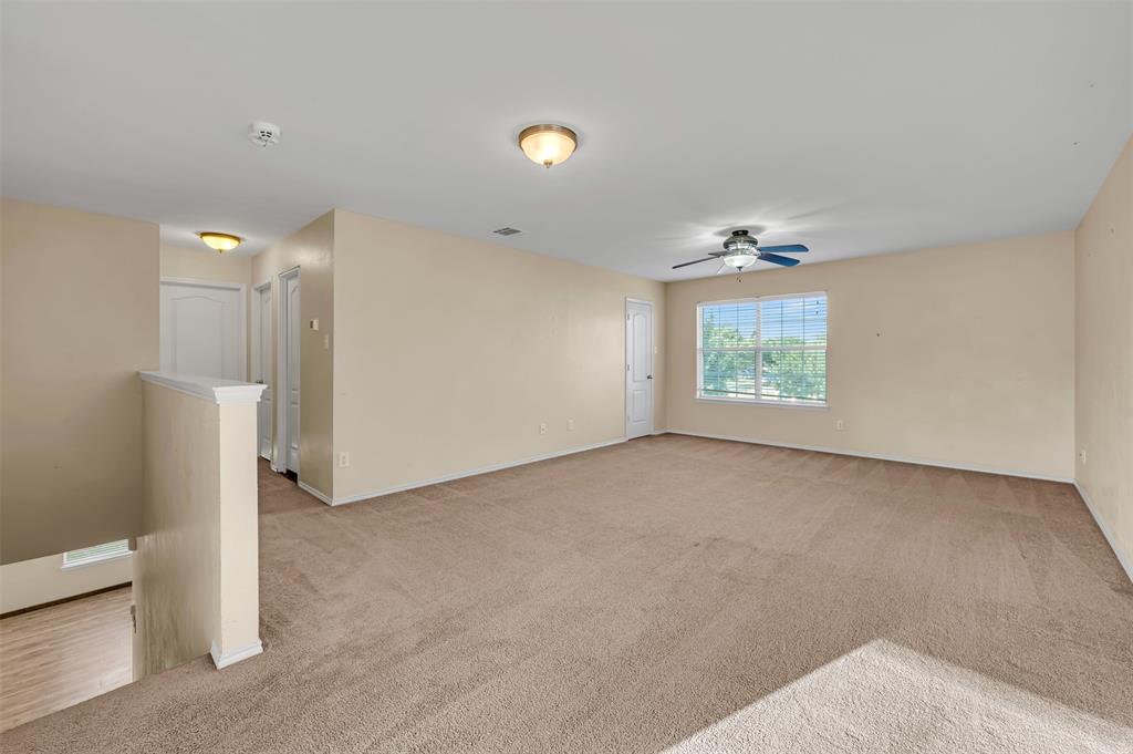 9017 Graywolf Ridge Trail Fort Worth, TX 76244 - Photo 14 of 27 Carpeted empty room with ceiling fan