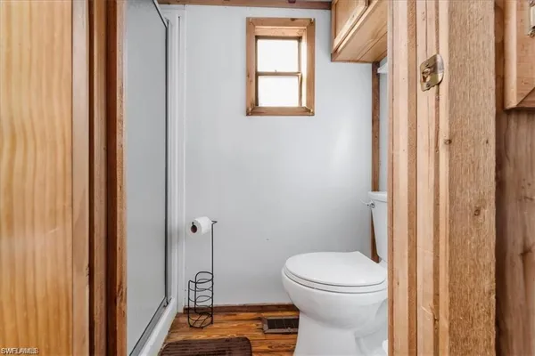 a bathroom with a toilet and a shower