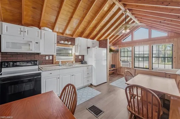 a kitchen with granite countertop a sink a counter space stainless steel appliances and cabinets