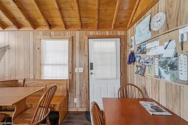 a view of a hallway with furniture and windows