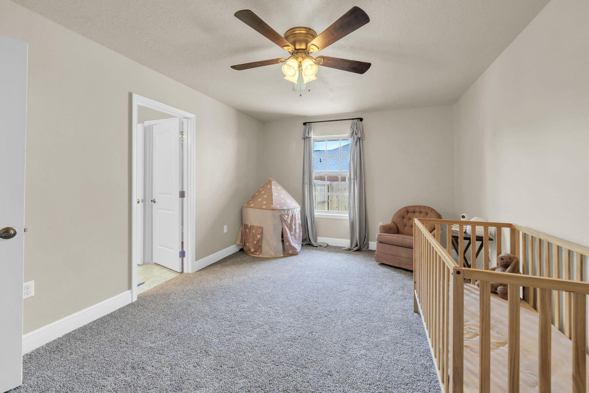 217 Raptor Drive Crestview, FL 32536 - Photo 36 of 48 a view of an empty room with window and a ceiling fan
