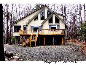 2594 Boulder Road Lake Ariel, PA 18436 - Photo 1 of 1 a front view of a house with a yard and trees