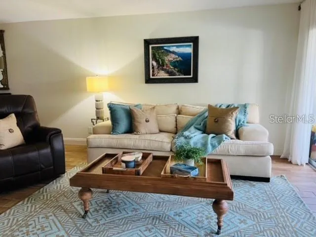 a living room with furniture and a rug