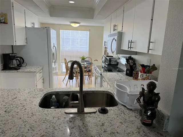 a kitchen with a sink and a refrigerator