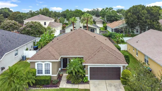 an aerial view of a house with yard and green space