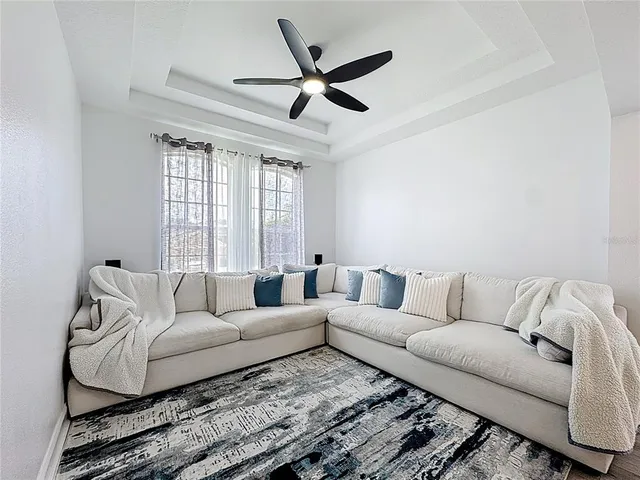 a kitchen with stainless steel appliances kitchen island granite countertop a stove a refrigerator and a dining table with wooden floor