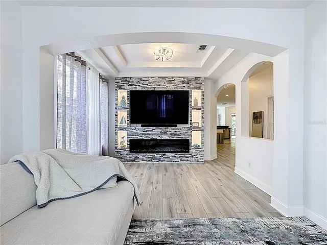 a dining room with furniture window and wooden floor