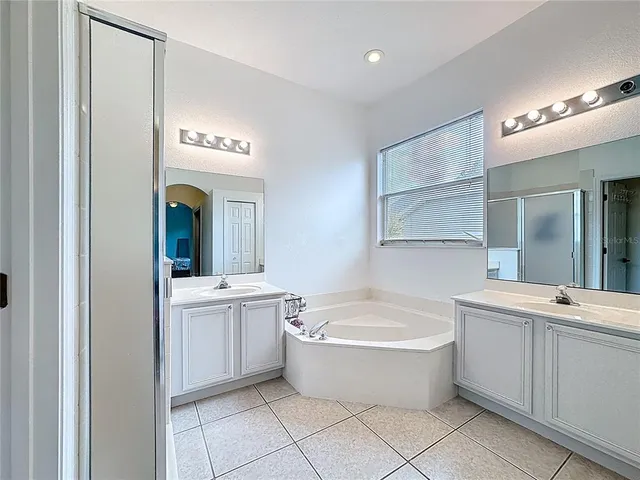 a bedroom with a large bed and a flat screen tv