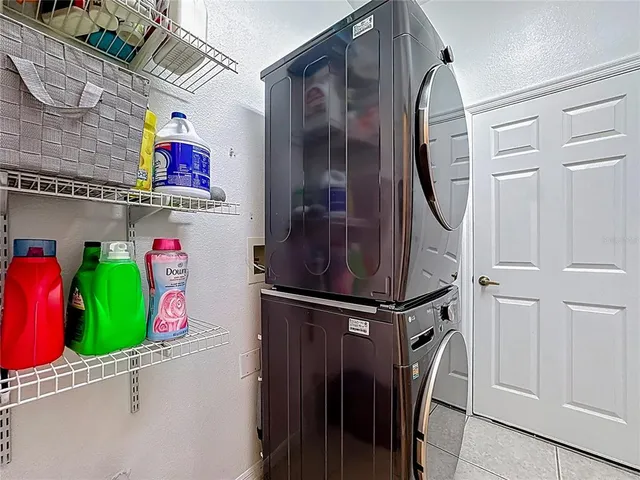 a large kitchen with stainless steel appliances lots of counter space and windows