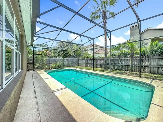 a kitchen with granite countertop a sink a stove and cabinets