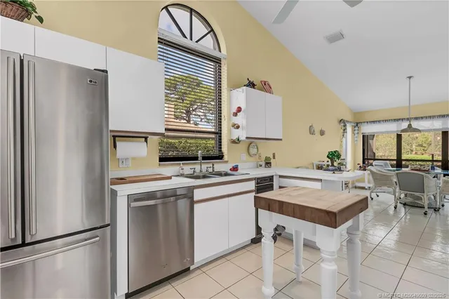 a kitchen with a sink appliances and cabinets