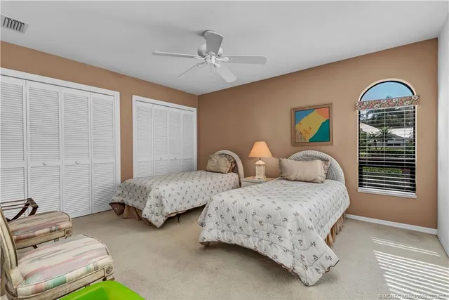 a bedroom with two beds and a chandelier