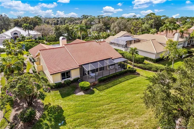 a aerial view of a house with a big yard and potted plants