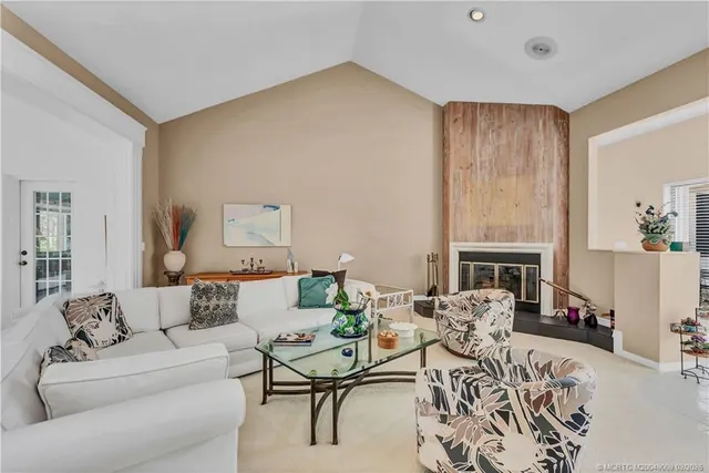 a living room with furniture a fireplace and a table