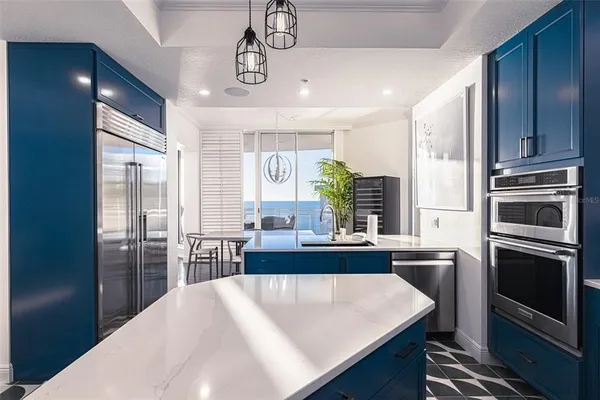 a large kitchen with kitchen island a sink stainless steel appliances and cabinets