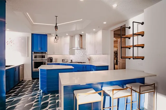 a kitchen with granite countertop stainless steel appliances and cabinets