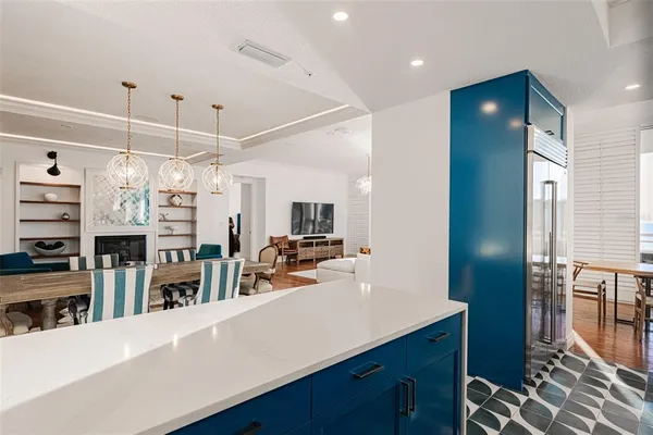 a large kitchen with stainless steel appliances kitchen island granite countertop a sink refrigerator and cabinets