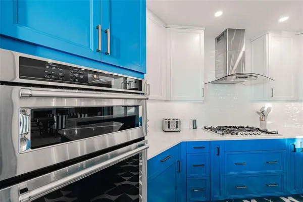 a kitchen with wooden cabinets and stainless steel appliances