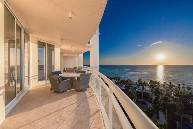 a view of a dining room with furniture a chandelier and wooden floor