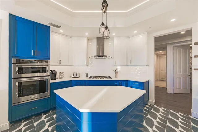 a view of a dining room with furniture a chandelier and wooden floor