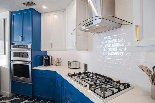 a kitchen with stainless steel appliances granite countertop a sink stove and refrigerator
