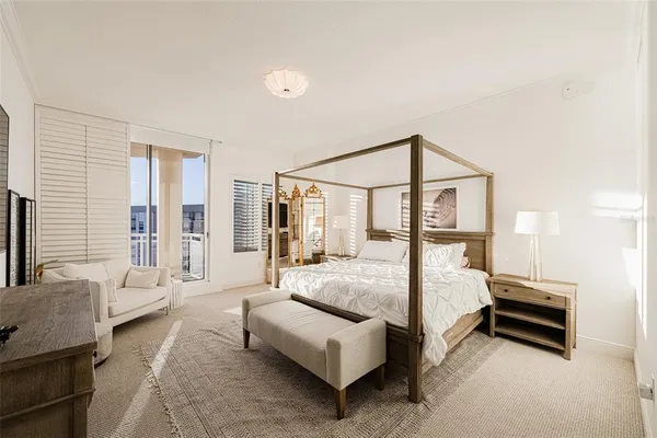a bedroom with a large bed and flat tv screen