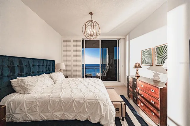 a bedroom with a bed and a chandelier