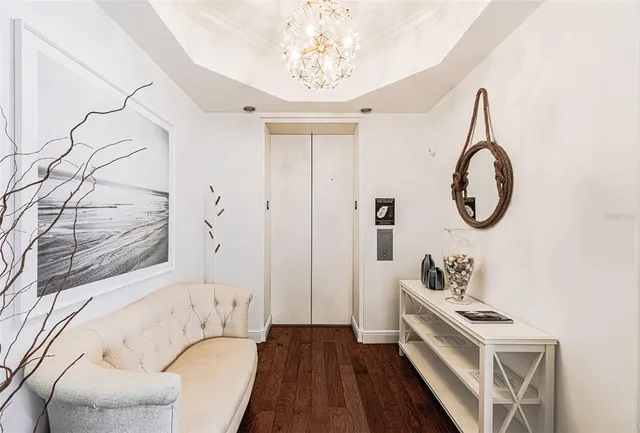 a living room with furniture a mirror and a clock