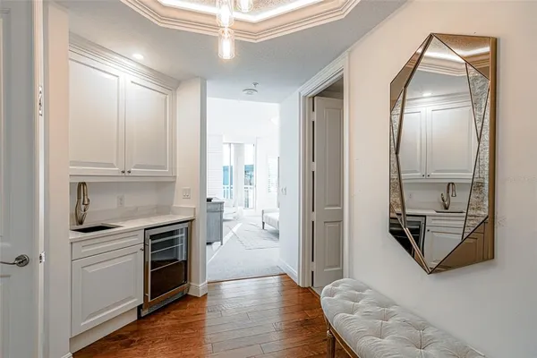 a living room with furniture and a mirror