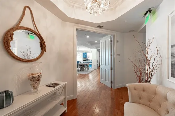 a living room with furniture a mirror and a clock