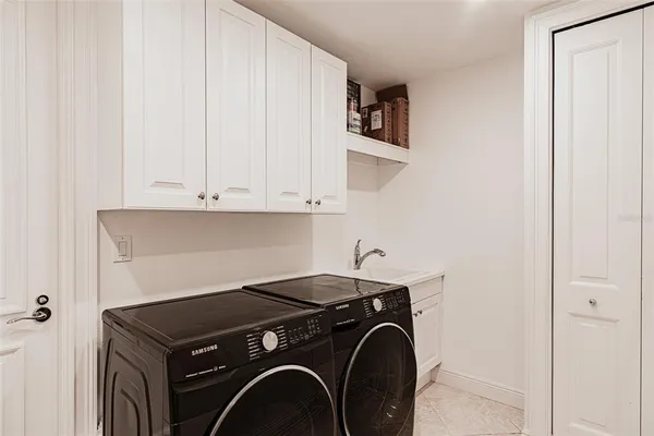 a view of a room with furniture and a chandelier
