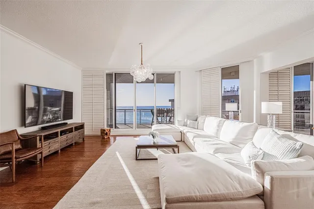 a living room with furniture fireplace and a large mirror