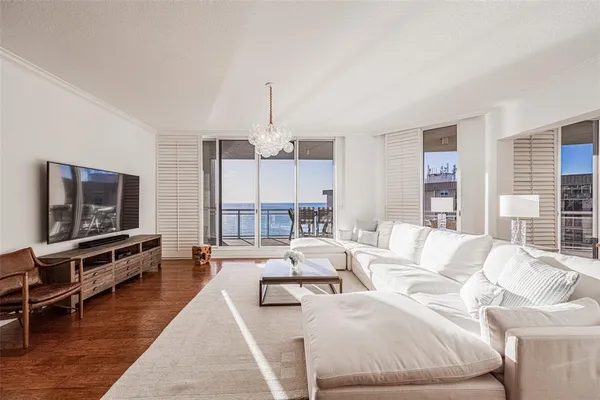 a living room with furniture or couch and a wooden floor