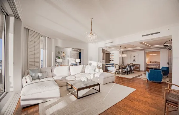 a living room with furniture fireplace and a large mirror