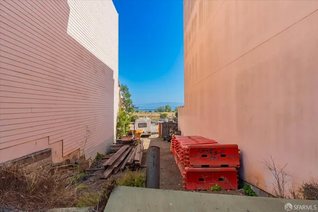 a view of a back yard with a table and chairs