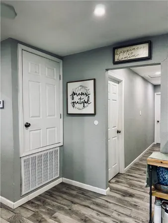 a view of a hallway with wooden floor