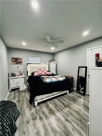 a bedroom with a bed and a view of kitchen