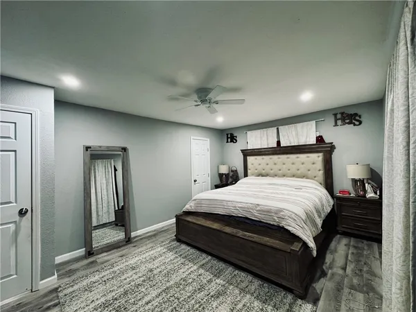 a bedroom with a bed and a mirror