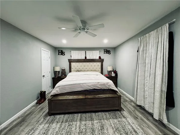 a large bed sitting in a room next to a window