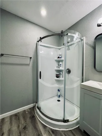 a bathroom with a shower and a mirror