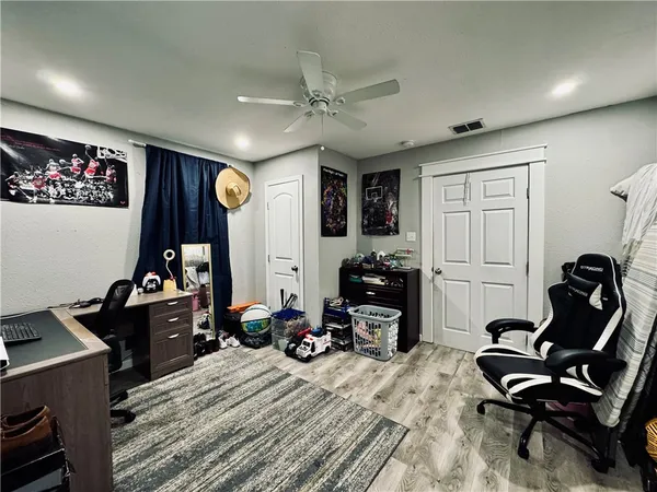 a view of a workspace with furniture and gym equipment
