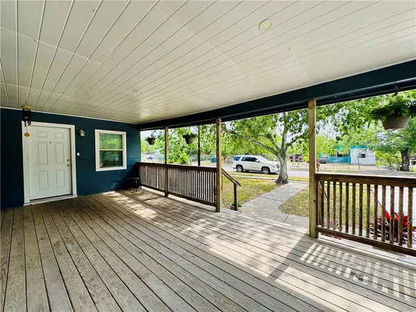 a view of porch with wooden floor and floor to ceiling window