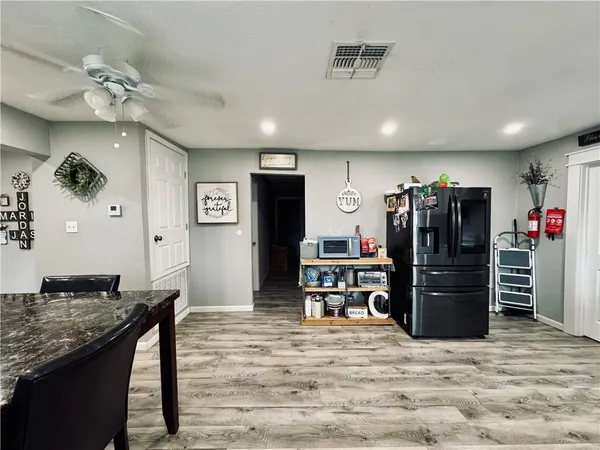 a view of a kitchen with a refrigerator and a stove