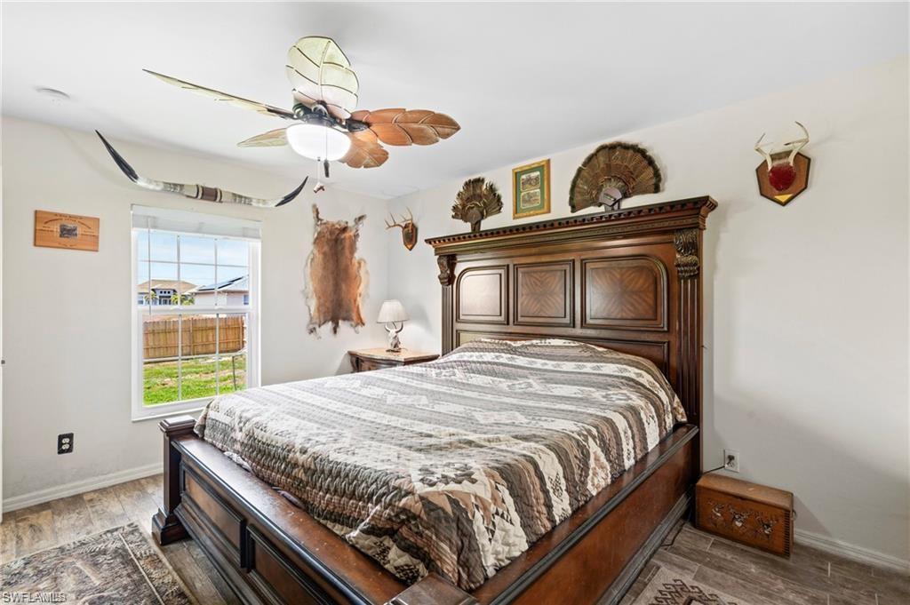 3303 32nd Street Southwest Lehigh Acres, FL 33976 - Photo 12 of 35 a bedroom with a bed and a window