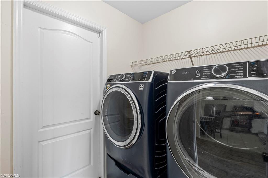 3303 32nd Street Southwest Lehigh Acres, FL 33976 - Photo 20 of 35 a utility room with dryer and washer