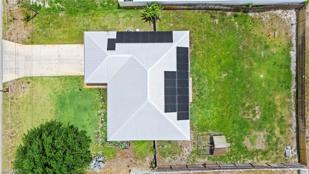 3303 32nd Street Southwest Lehigh Acres, FL 33976 - Photo 25 of 35 a aerial view of a house with garden space and trees