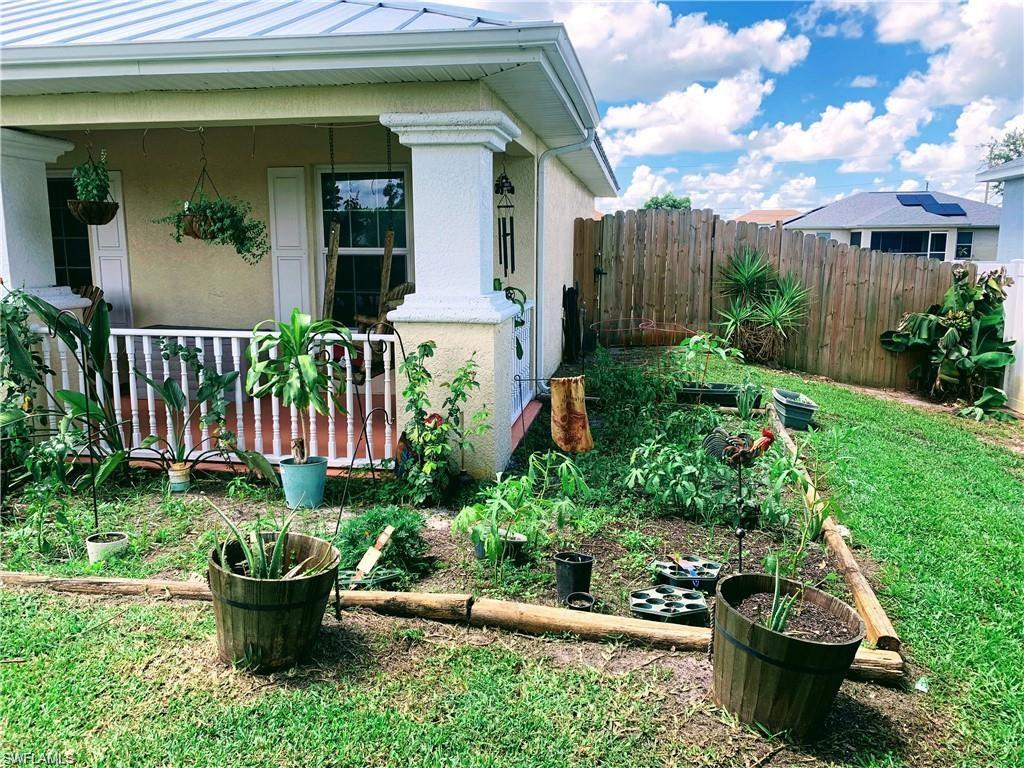 3303 32nd Street Southwest Lehigh Acres, FL 33976 - Photo 30 of 35 a view of a garden filled with potted plants
