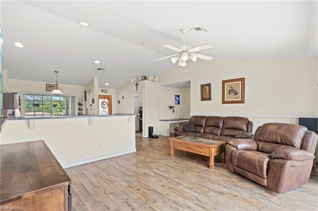 3303 32nd Street Southwest Lehigh Acres, FL 33976 - Photo 4 of 35 a living room with furniture and kitchen view
