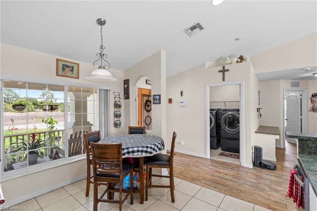 3303 32nd Street Southwest Lehigh Acres, FL 33976 - Photo 7 of 35 a view of a dining room with furniture window and wooden floor