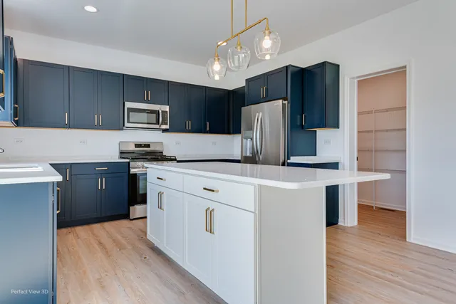 a kitchen with stainless steel appliances a refrigerator sink and microwave